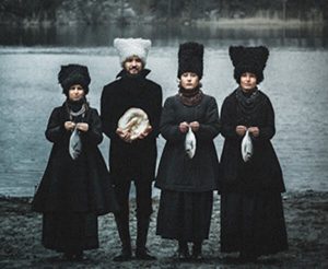 dakhabrakha - pilgrims standing in front of a lake